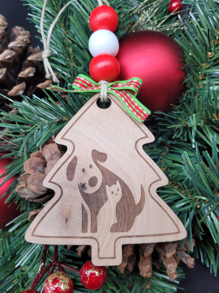Dog cat hugs around Christmas tree
